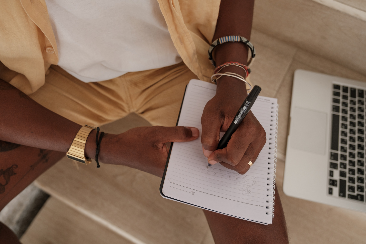 Man Writing on Notebook